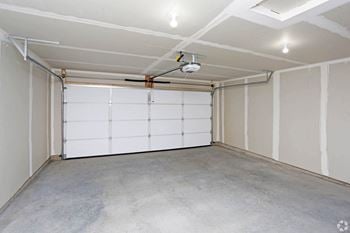 A white garage with a white door and white walls